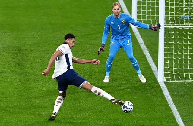 Jude Bellingham of England attempts to keep the ball in play whilst under pressure from Caoimhin Kelleher