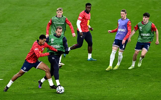 Jude Bellingham and Harry Kane of England battle for possession