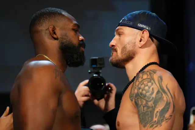 Jon Jones and Stipe Miocic stand face-to-face