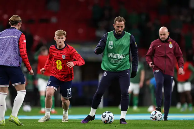 Harry Kane and England's defender #12 Lewis Hall (Centre L) warm up