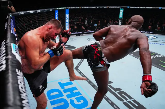 Jon Jones lands a spinning back heel on Stipe Miocic