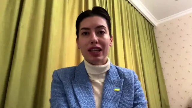 Maria Mezentseva, a Ukrainian MP, speaking to BBC in a room with a light green curtain background