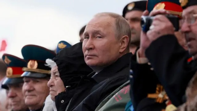 Russian President Vladimir Putin watches a military parade on Victory Day, which marked the 77th anniversary of the victory over Nazi Germany in World War Two, in Red Square in central Moscow