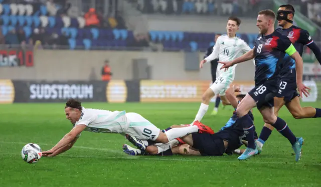 NI striker Dion Charles goes down under a challenge against Luxembourg