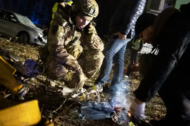 Emergency services inspect a fire at a site hit by Russian missiles in Sumy