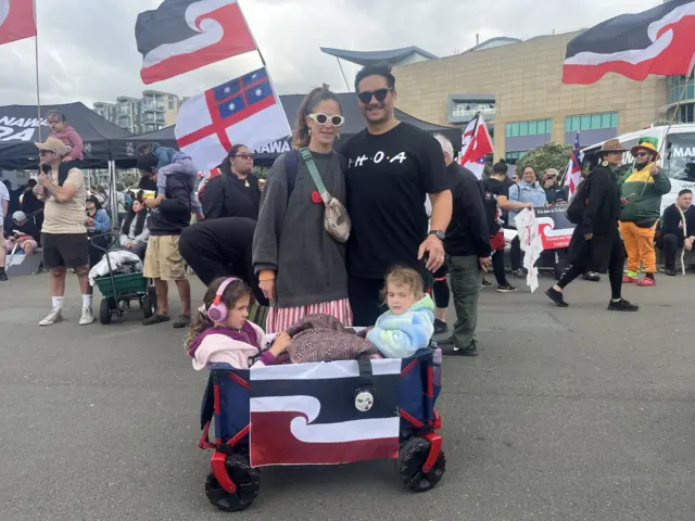 Aly Payne, Emily and their two children who are sitting in a wagon