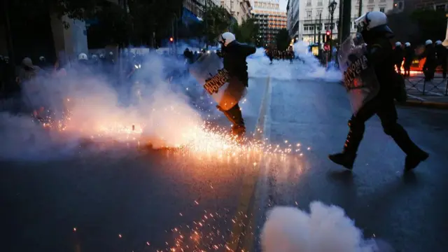 Riot police use tear gas granades to disperse pro-refugees activists as they demonstrate to protest the loss of hundreds of asylum seekers who were aboard a boat that capsized off the coast of Peloponnese, in Athens, Greece, 15 June 2023