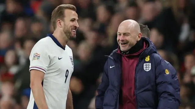 Harry Kane laughing with Lee Carsley