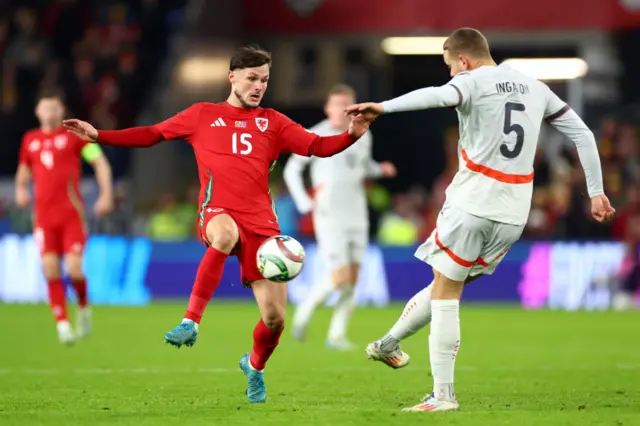 Liam Cullen of Wales (L) challenges Sverrir Ingason of Iceland