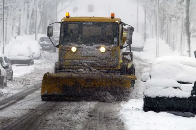 A gritting lorry on a snow covered road