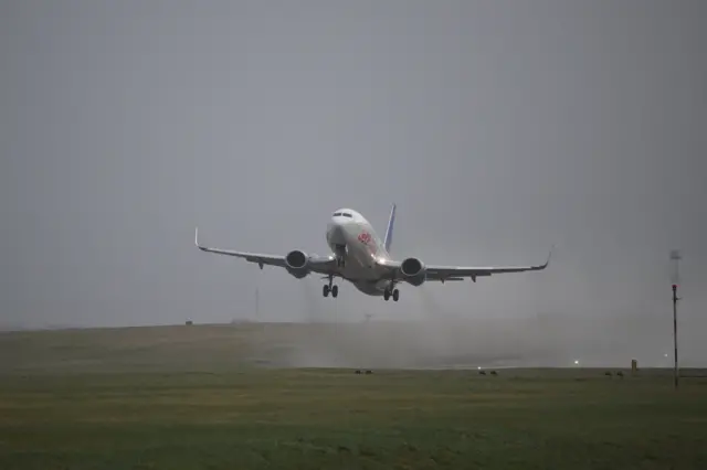 A plane comes into land during wet conditions