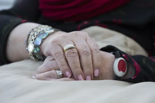 A close-up of an elderly lady's hands