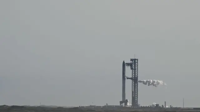 The SpaceX Starship is seen on the launchpad at Starbase in Boca Chica, Texas, with smoke billowing out next to it