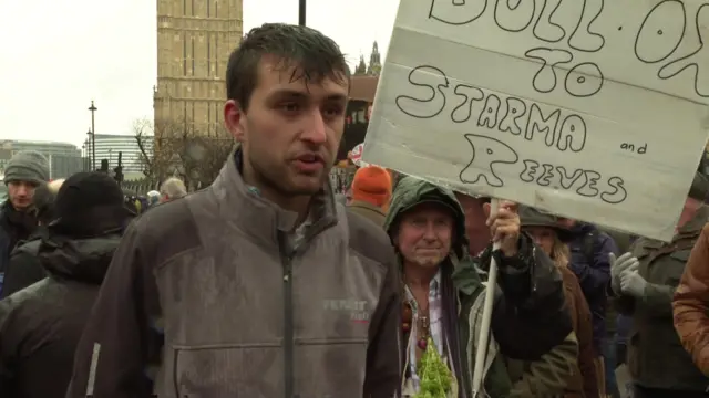 Henry Hickam at the protest, many people are in the background