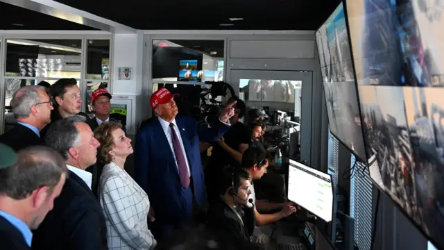 U.S. President-elect Donald Trump looks on as Elon Musk explains the operations of the launch of the sixth test flight of the SpaceX Starship rocket in a control room, in Brownsville, Texas,