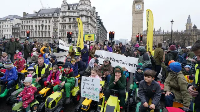 Dozens of children on toy tractors during a farmers protest in central London