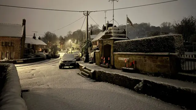 A street with a light covering of snow