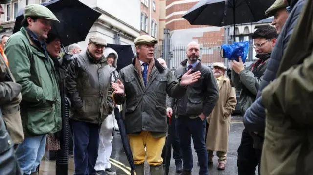 Britain's Reform party leader Nigel Farage, speaks with protesters during the demonstration protesting against the Labour government's new agricultural policy