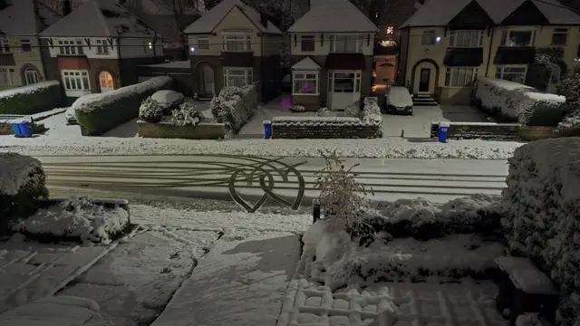 A snow-covered residential street in Sheffield