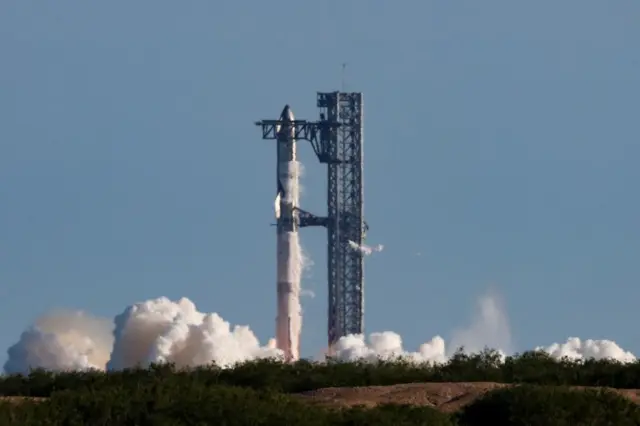 Smoke and steam seen emanating from the rocket on the launch pad