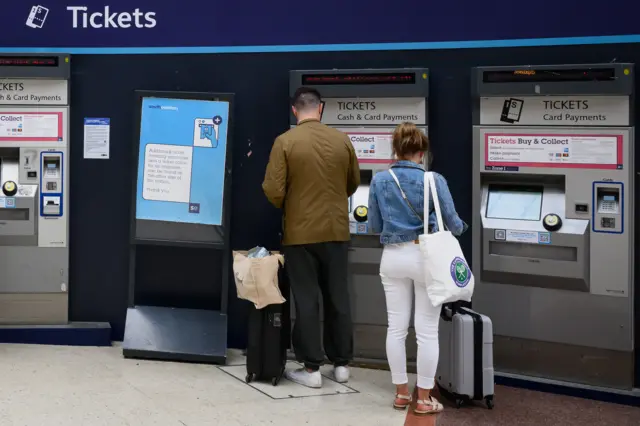 People queuing at a ticket machine