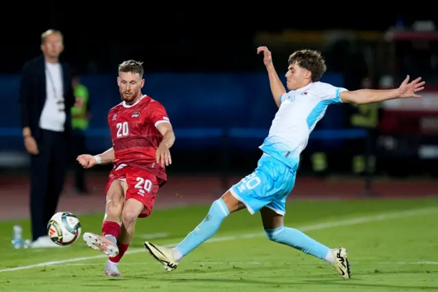 Sandro Wolfinger of Liechtenstein and Nicko Sensoli of San Marino compete for the ball