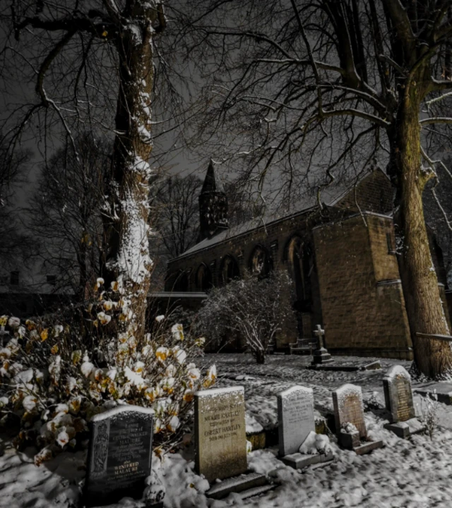 graveyard of St Thomas of Gawber church covered in snow