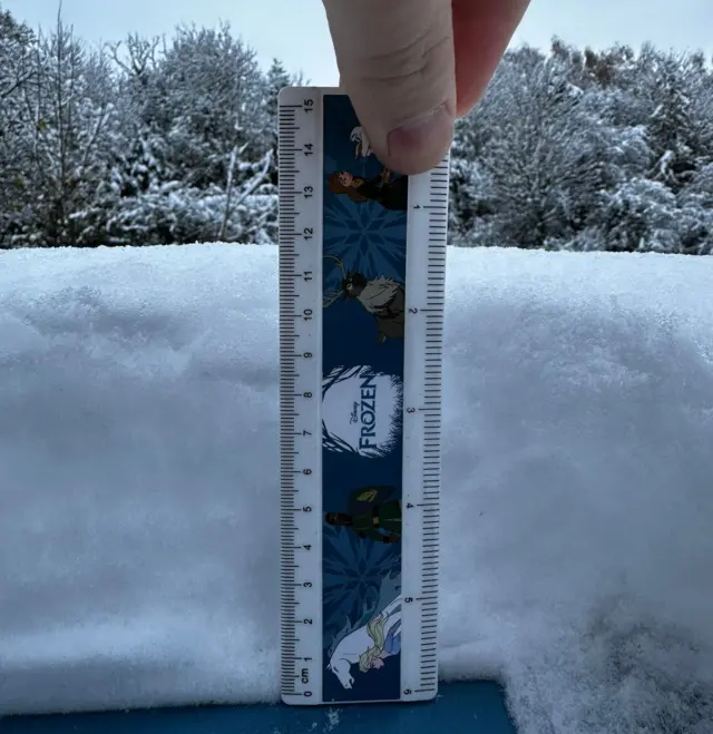 A ruler, with Disney's Frozen branding, showing the depth of snow in Ollerton