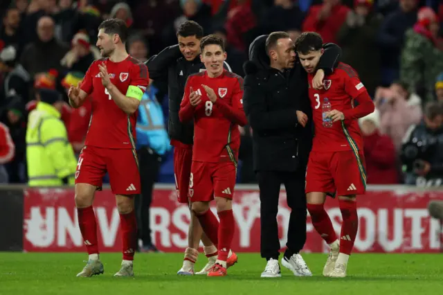 Wales players and staff celebrate at full time