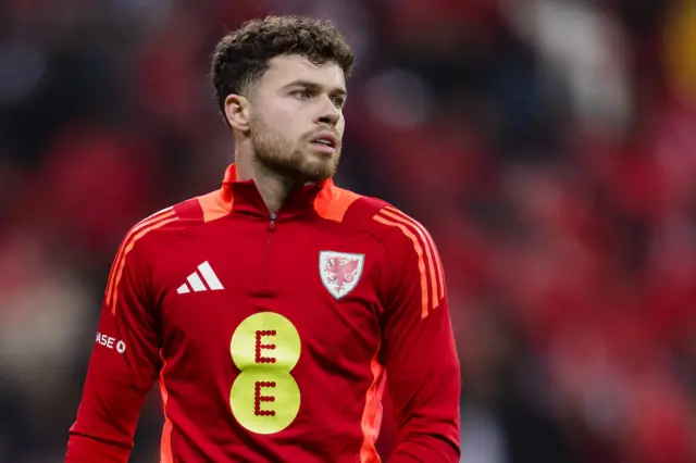 Neco Williams warms up for Wales