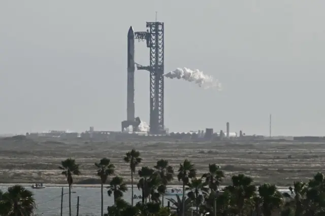 A long distance shot of the rocket on the launch pad