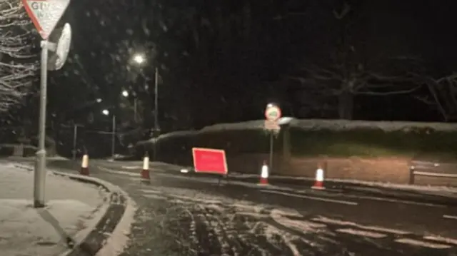 Grane Road with snow showing a red road closed sign