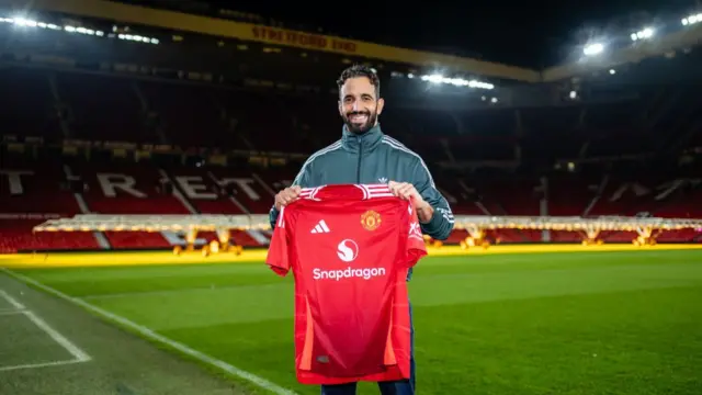 New Manchester United manager Ruben Amorim poses with Man United jersey.