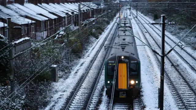 A train on tracks covered in snow