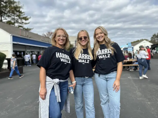 Kim Carpenter (left) and her daughters at Harris rally in Charlotte, North Carolina wearing branded Harris t-shirts