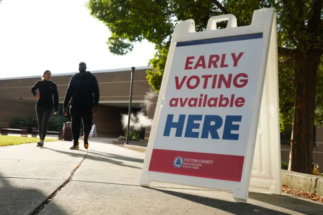 Signs direct people where to go to cast their votes on the first day of early voting at Atlanta Metropolitan State College on October 15, 2024 in Atlanta, Georgia