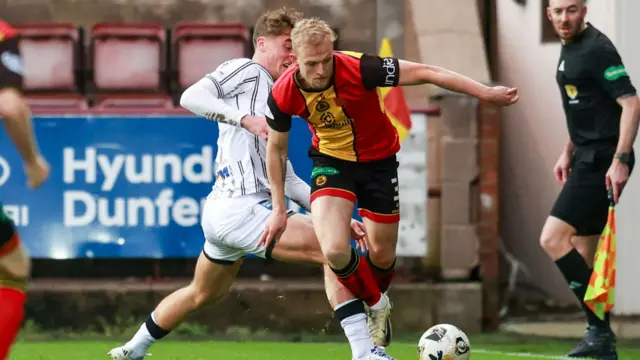 Dunfermline's Lewis McCann challenges Partick Thistle's Harry Milne