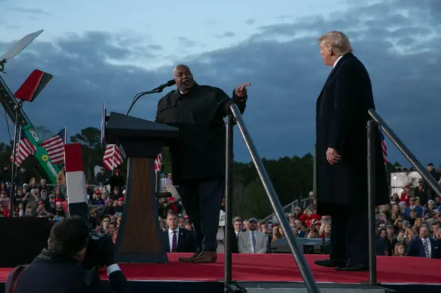 Mark Robinson (left) onstage at a rally with Donald Trump (right)