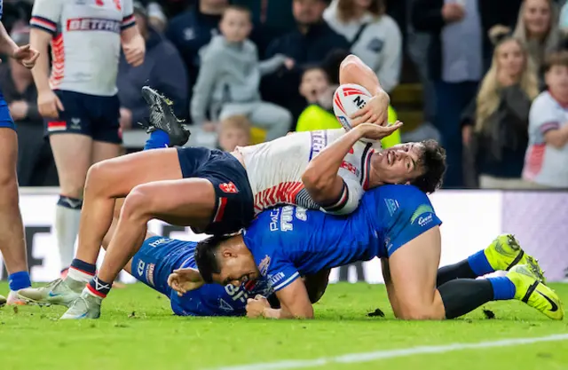 England's Herbie Farnworth is held up by Samoa's Roger Tuivasa-Sheck at the goal lin