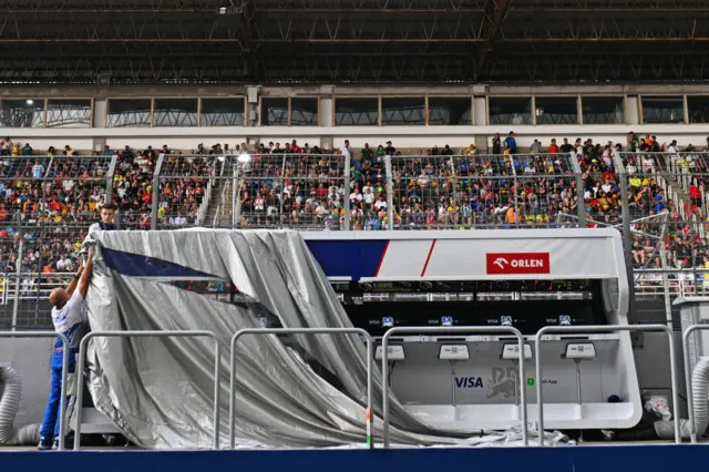 RB cover their pitwall to protect it from the rain