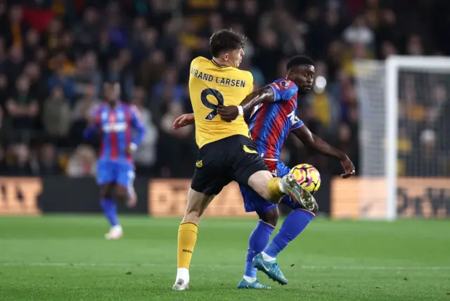 Joergen Strand Larsen of Wolverhampton Wanderers battles for possession with Marc Guehi of Crystal Palace