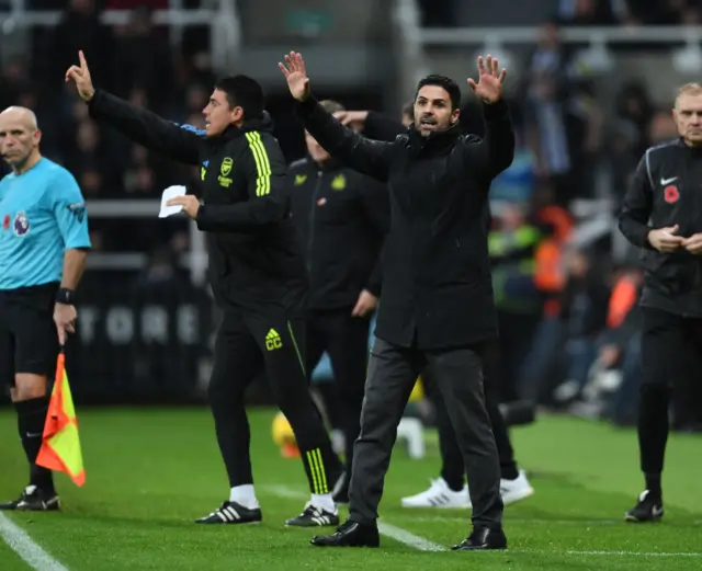 Mikel Arteta with his arms up on the touchline