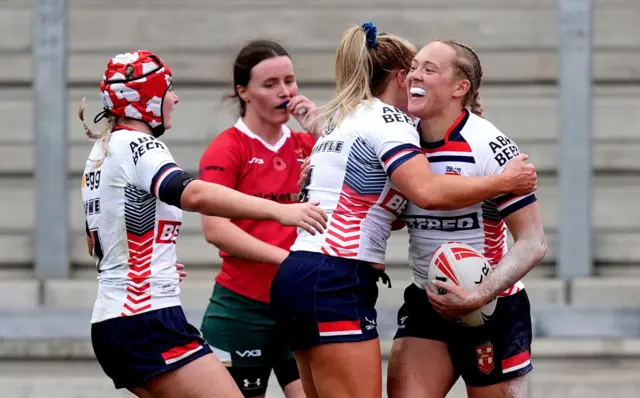 England's Anna Davies (right) celebrates her try