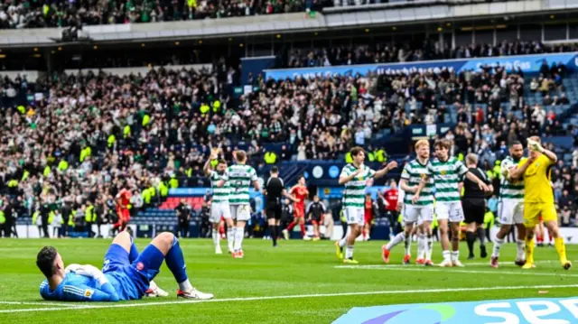 Aberdeen's Kelle Roos watches the Celtic players celebrate at full time during a Scottish Gas Scottish Cup semi-final match between Aberdeen and Celtic at Hampden Park, on April 20, 2024.