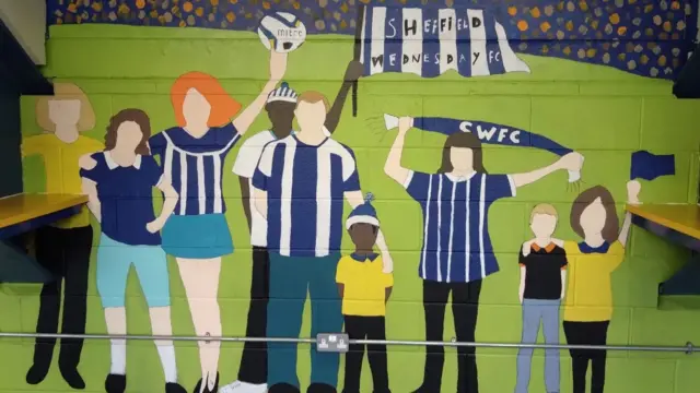 A colourful mural at Hillsborough depicting fans of all ages and colours