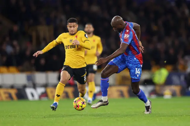 Jean-Philippe Mateta of Crystal Palace is challenged by Joao Gomes of Wolverhampton Wanderers