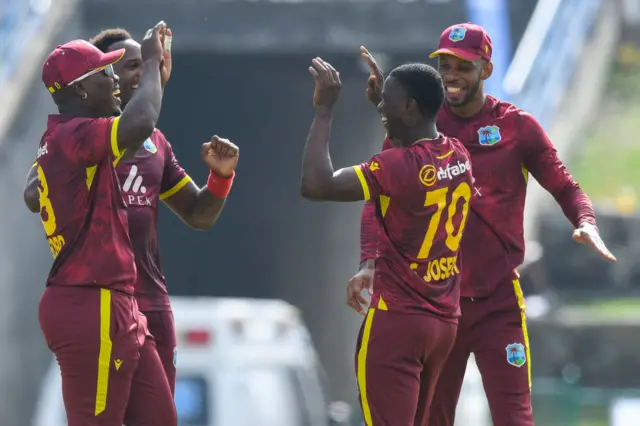 West Indies celebrate the dismissal of Jordan Cox of England