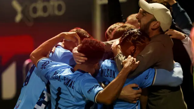 Kettering players celebrate with fans