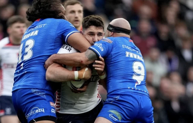 Victor Radley is tackled by Samoa's Luciano Leilua (left) and Jazz Tevaga