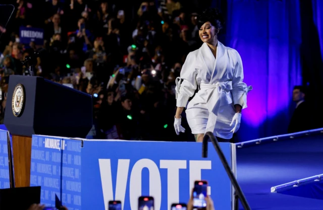 Dressed in a white outfit and gloves, Cardi B attends a campaign rally for Democratic presidential nominee and U.S. Vice President Kamala Harris at Wisconsin, in Milwaukee